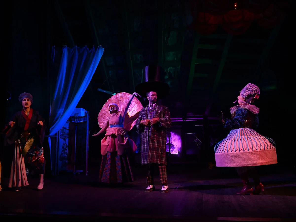 Four performers in vintage theatrical costume on a dimly lit stage (representative photograph of a variety-theatre ensemble, not this venue's own cast)